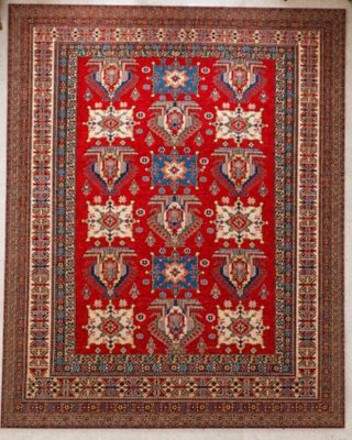 a red rug hanging on a wall in a room