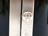 a close up of a metal door handle on a black door