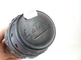 a hand holding a black bottle with a sticker on it