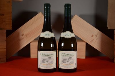 two bottles of wine sitting next to each other on a table