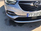 a close up of the front of a car with a number plate on it
