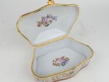 a close up of a small box with flowers on it