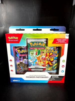 two pokemon cards are in a box on a black surface