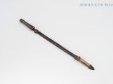 an old pen sitting on top of a white table next to a pencil