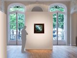 a white sculpture in a room with a painting on the wall