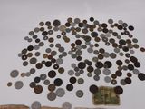 a lot of coins on the table next to a pile of money