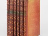 a set of five antique books sitting on top of each other