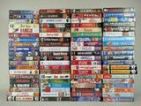 many dvds stacked on top of each other on a table