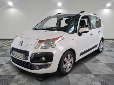 the small white car is parked in a large room