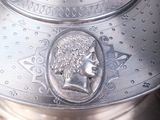 a large silver pot with a lid on a table