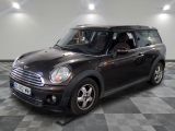 a picture of a black mini cooper parked in a garage