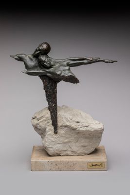 statue of a woman on a rock with a bird in her hand