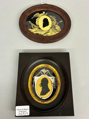two framed images of a man and woman in silhouettes on a wall