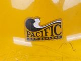 a sticker that says pacific new zealand on the side of a yellow truck