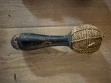 a ball of yarn wrapped around a wooden handle