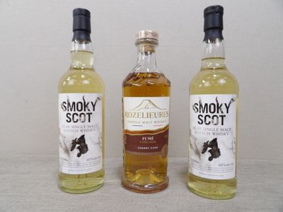 Trois bouteilles de whisky fumé sont alignées sur une table