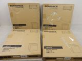 three boxes of electronic equipment sitting on top of a white surface