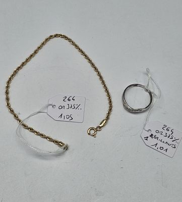 two rings and a chain on a white surface