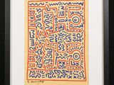 an image of a framed artwork of a square with blue, red and yellow letters