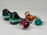 three glass birds sitting on top of each other on a table