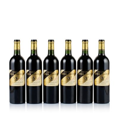 six bottles of red wine lined up in a row