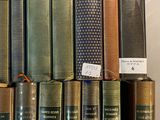 a lot of books that are sitting on a shelf