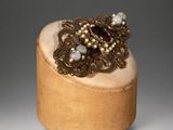 wooden box with a ring on top of it on a table