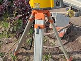 Quelqu'un utilise un trépied pour mesurer la hauteur d'un camion.