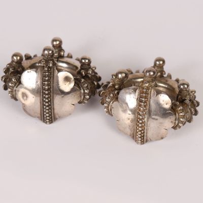 pair of silver earrings with pearls and beads on a white background