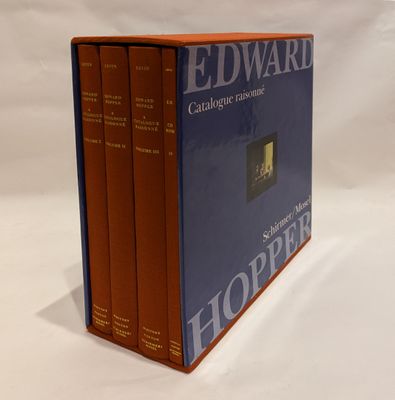 three books are stacked on top of each other on a white surface