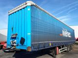 a blue semi trailer parked in a parking lot