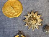 a lot of badges on a table with a brush