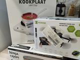 three boxes of food sit on a table next to a blender and a blender