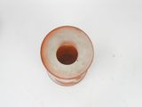 a small glass vase with a brown substance inside of it