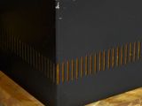 an image of a black and gold clock on a wooden stand