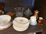 a table with a bunch of dishes and cups on it