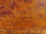 an old wooden box with a painting of a bird on it ' s side