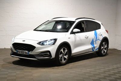 the white car is parked in the garage with a blue decal on the side of it