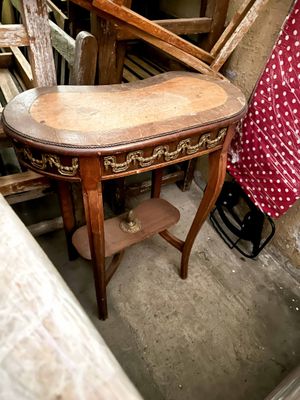a wooden table with a red polka dot dress on it