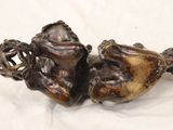 two figurines that are sitting on a white surface