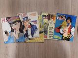 three comics are sitting on a wooden table next to each other