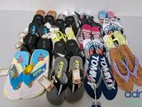 many pairs of flip flops that are on a table