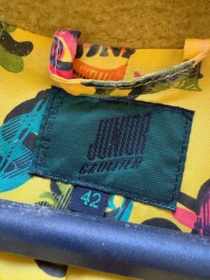 un gros plan sur un sac jaune muni d'une poignée bleue