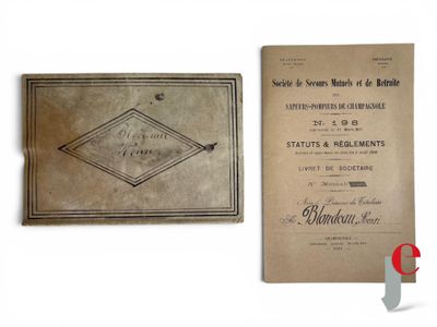 an old book sitting on top of a table next to a paper