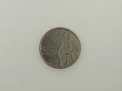 a close up of a coin on a white surface with a white background