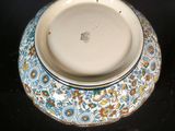a blue and white bowl with a floral design on it