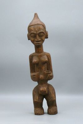 a wooden statue of a man with a hat on his head