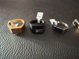 three different types of rings on a black surface