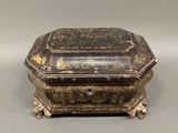 an old wooden box sitting on top of a gray surface