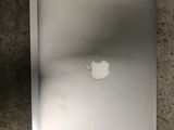an apple laptop computer sitting on top of a table next to a cup